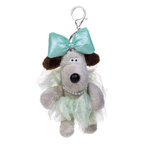 Load image into Gallery viewer, A plush dog keychain or bag charm with a mint green bow, a pale mint tulle skirt, and a rhinestone collar, attached to a silver lobster clasp on a white background.
